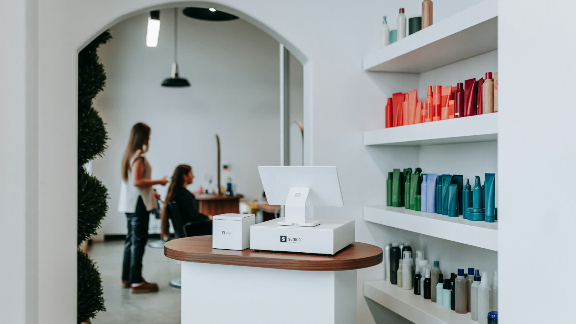 A reception desk, a professional working with a client behind